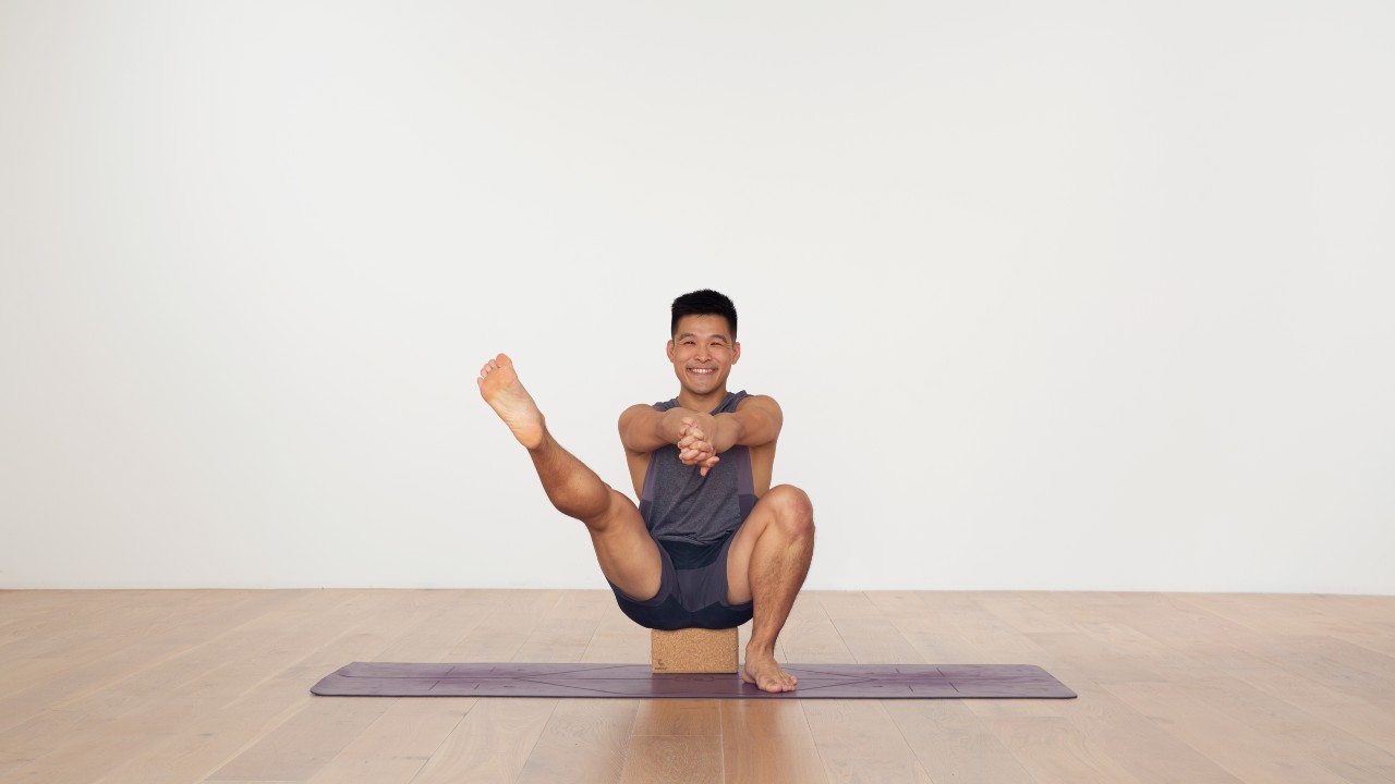 David Kam sitting on yoga block