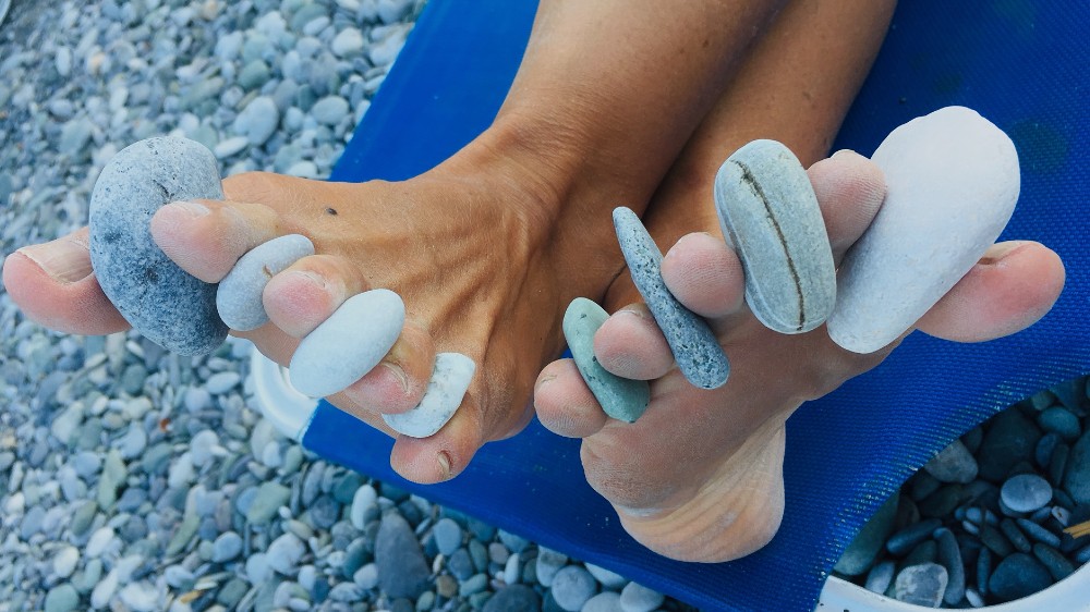 pebbles between toes